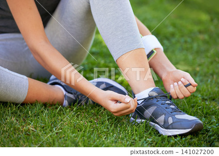 Shoes, hands and tie shoelace in park, ready for run or cardio for fitness and sports outdoor. Exercise, workout and person with sneakers on grass for training, health and wellness with runner Shoes, hands and tie shoelace in park, ready for run or cardio for fitness and sports outdoor. Exercise, workout and person with sneakers on grass for training, health and wellness with runner 141027200
