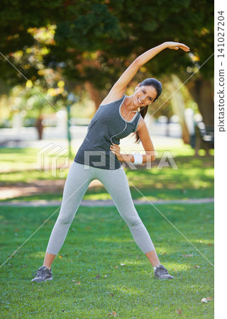 Portrait, woman and happy with headphones for stretching, exercise and podcast for training motivation. Female person, smile and fitness in park with balance warm up, wellness and music in earphones Portrait, woman and happy with headphones for stretching, exercise and podcast for training motivation. Female person, smile and fitness in park with balance warm up, wellness and music in earphones 141027204