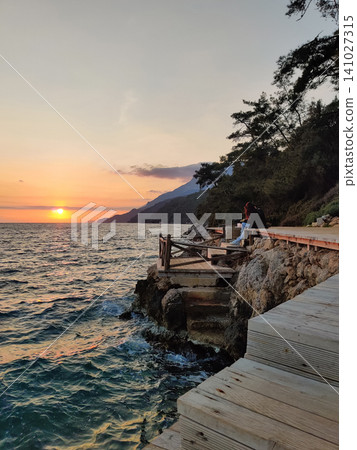 a beautiful wooden pier on the seashore for walkinga beautiful wooden pier on the seashore for walking 141027315
