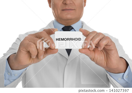 Doctor holding business card with word HEMORRHOID on white background, closeup Doctor holding business card with word HEMORRHOID on white background, closeup 141027397