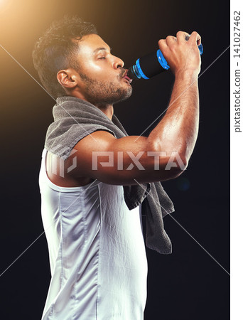 Fitness, studio and man with muscle drinking water, relax and workout routine for health, wellness and power. Bottle, hydrate and strong athlete on black background for exercise, results and progress Fitness, studio and man with muscle drinking water, relax and workout routine for health, wellness and power. Bottle, hydrate and strong athlete on black background for exercise, results and progress 141027462