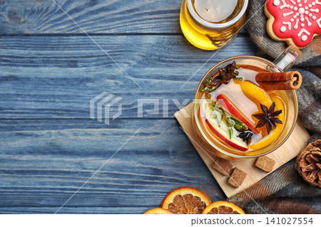 Aromatic mulled wine on blue wooden table, flat lay. Space for text Aromatic mulled wine on blue wooden table, flat lay. Space for text 141027554