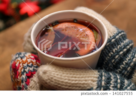 Woman with cup of mulled wine at counter, closeup 141027555