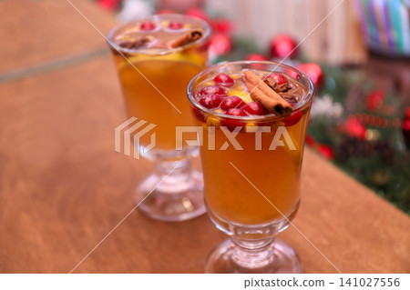 Tasty aromatic mulled wine on wooden table Tasty aromatic mulled wine on wooden table 141027556