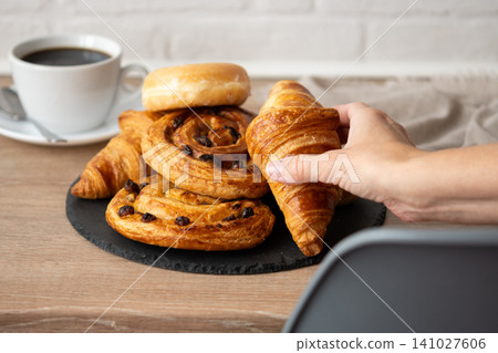 Hand Taking Croissant Hand Taking Croissant 141027606