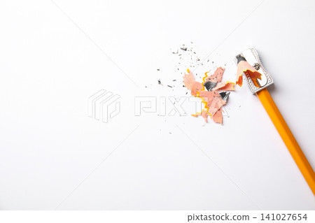 Graphite pencil, shavings and sharpener on white background, top view. Space for text Graphite pencil, shavings and sharpener on white background, top view. Space for text 141027654