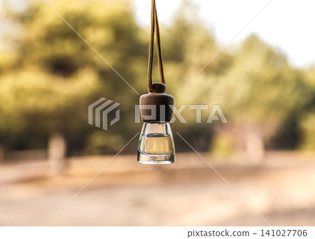Car air freshener hanging on blurred view, closeup Car air freshener hanging on blurred view, closeup 141027706