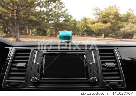 Stylish air freshener on dashboard in car 141027707