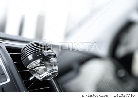 Stylish air freshener clip attached to car ventilation. Space for text Stylish air freshener clip attached to car ventilation. Space for text 141027710