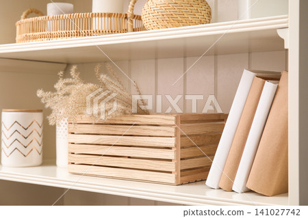 White shelving unit with books and different decorative stuff White shelving unit with books and different decorative stuff 141027742