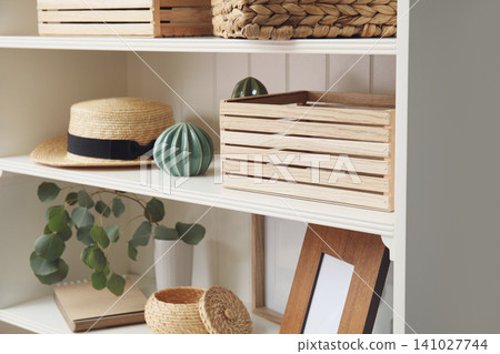 White shelving unit with different decorative stuff 141027744