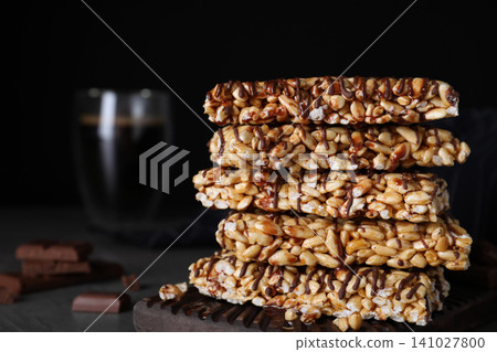 Delicious rice crispy treats on black background Delicious rice crispy treats on black background 141027800