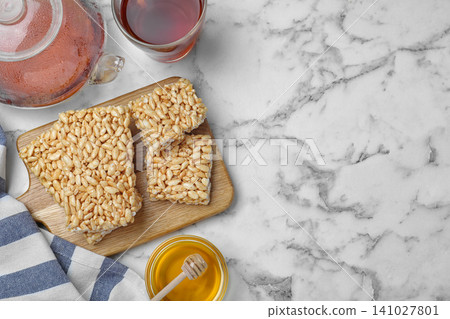 Delicious rice crispy treats on white marble table, flat lay. Space for text 141027801