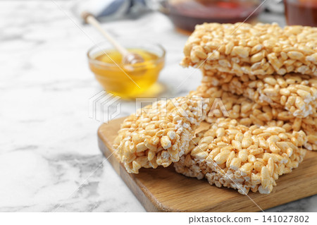 Delicious rice crispy treats on white marble table, closeup. Space for text Delicious rice crispy treats on white marble table, closeup. Space for text 141027802