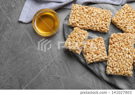 Delicious rice crispy treats on grey table, flat lay Delicious rice crispy treats on grey table, flat lay 141027803