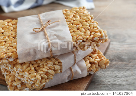 Delicious rice crispy treats on wooden table, closeup Delicious rice crispy treats on wooden table, closeup 141027804