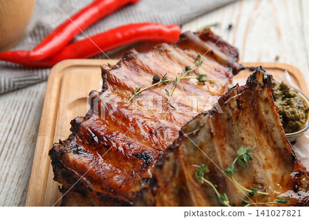 Tasty grilled ribs with thyme on white wooden table, closeup 141027821