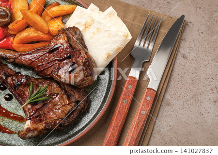 Delicious grilled ribs served on light grey table, flat lay Delicious grilled ribs served on light grey table, flat lay 141027837
