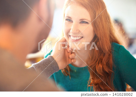 Cafe, couple and touch on face of woman with happiness, smile and relax in date with man. Adult, female person and girl with guy or partner with hand to caress in coffee shop and joy for marriage 141028002
