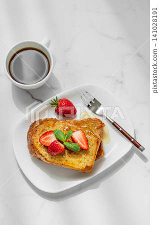 Brioche toasts with strawberry and honey on a plate on a marble background Brioche toasts with strawberry and honey on a plate on a marble background 141028191