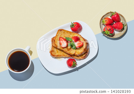 Brioche toasts with strawberries and honey on a plate on a yellow blue background 141028193