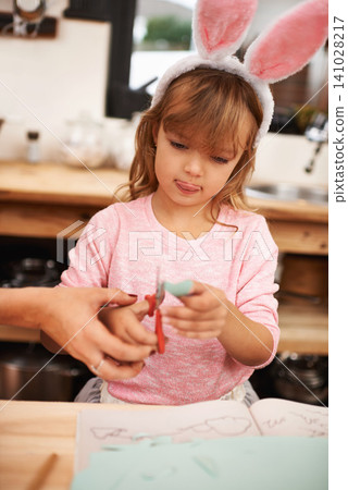 Little girl, bunny ears and cutting with scissors for arts and crafts, class project or decor. Closeup of child or kid with pattern, outline or paper shape in artwork for easter holiday at school Little girl, bunny ears and cutting with scissors for arts and crafts, class project or decor. Closeup of child or kid with pattern, outline or paper shape in artwork for easter holiday at school 141028217