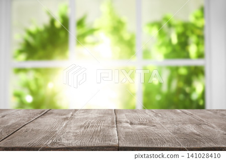 Empty wooden table in front of window. Sunny morning Empty wooden table in front of window. Sunny morning 141028410