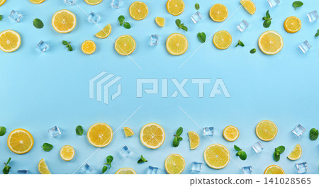 Frame made of lemon slices, mint and ice on light blue background, top view with space for text. Lemonade layout 141028565