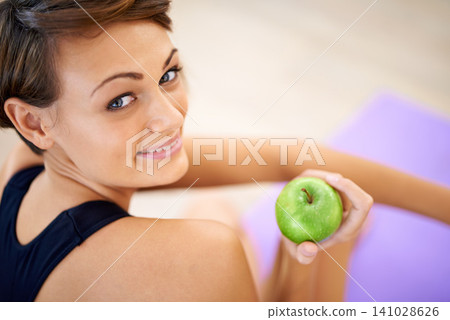 Portrait, fitness and happy woman with apple in gym for diet, nutrition or wellness with healthy body. Face, smile and person with green fruit and eating organic food with vitamin c for benefits Portrait, fitness and happy woman with apple in gym for diet, nutrition or wellness with healthy body. Face, smile and person with green fruit and eating organic food with vitamin c for benefits 141028626
