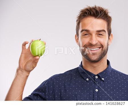 Studio, smile and portrait of man with apple for nutrition, healthy diet and weight loss. Green fruit, organic food and man with happiness for detox, self care and vitamin c on white background Studio, smile and portrait of man with apple for nutrition, healthy diet and weight loss. Green fruit, organic food and man with happiness for detox, self care and vitamin c on white background 141028627