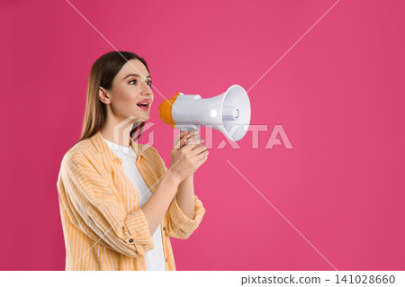 Young woman with megaphone on pink background. Space for text Young woman with megaphone on pink background. Space for text 141028660