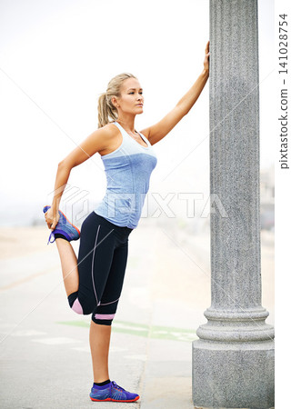 Training, thinking or woman stretching legs for exercise, running or fitness workout in Athens, Greece. Muscle warm up, runner or sports athlete ready to start practice for wellness, body or balance 141028754