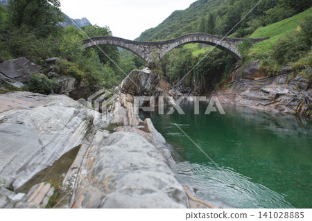 Ponte dei Salti double arch stone bridge over turquoise Verzasca river in Switzerland 141028885
