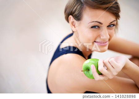 Portrait, exercise and happy woman with apple in gym for diet, nutrition or wellness with healthy body. Face, fitness and person eating fruit for vitamin c or benefits of organic food on mockup space Portrait, exercise and happy woman with apple in gym for diet, nutrition or wellness with healthy body. Face, fitness and person eating fruit for vitamin c or benefits of organic food on mockup space 141028898