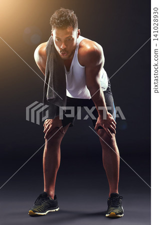 Fitness, relax and man in studio with breathing, sweat and exhausted commitment to muscle workout. Air, rest and tired athlete on black background for exercise, towel and fatigue in morning training. 141028930