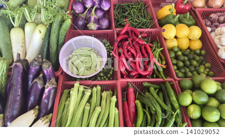 Fresh vegetables and citrus fruits displayed in colorful market baskets for healthy food Fresh vegetables and citrus fruits displayed in colorful market baskets for healthy food 141029052