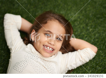 Portrait, child or happy to relax in childhood, fun or play on grass in garden, park or backyard. Smile, girl or lying in free time, leisure or break in carefree, outdoor activities on mockup space Portrait, child or happy to relax in childhood, fun or play on grass in garden, park or backyard. Smile, girl or lying in free time, leisure or break in carefree, outdoor activities on mockup space 141029131