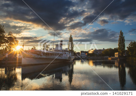 Historic paddle steamer at sunset in Interlaken harbor Switzerland Historic paddle steamer at sunset in Interlaken harbor Switzerland 141029171