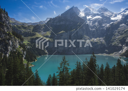 The breathtaking turquoise Oeschinen Lake surrounded by the Swiss Alps in Kandersteg The breathtaking turquoise Oeschinen Lake surrounded by the Swiss Alps in Kandersteg 141029174