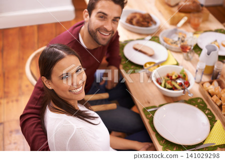 Smile, dinner and portrait of couple at table with family, food, and drinks for celebration in home. Social event, man and woman at thanksgiving lunch together with high angle, relax and holiday Smile, dinner and portrait of couple at table with family, food, and drinks for celebration in home. Social event, man and woman at thanksgiving lunch together with high angle, relax and holiday 141029298