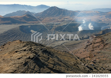 The dynamic crater and rising white plume of smoke from the Aso Nakadake volcano. The dynamic crater and rising white plume of smoke from the Aso Nakadake volcano. 141029355
