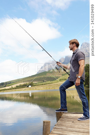 Fishing, pole and man in nature for travel, break or stress relief at a lake on vacation, holiday or trip. Fish, line and calm male person at outdoor river for water, adventure or peace in a forest Fishing, pole and man in nature for travel, break or stress relief at a lake on vacation, holiday or trip. Fish, line and calm male person at outdoor river for water, adventure or peace in a forest 141029499
