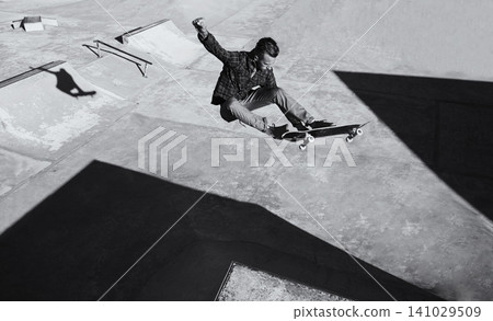 Man, jump and skateboard at skatepark for training with practice or hobby to play tricks. Monochrome, exercise and experience on break or leisure to enjoy for activity, sport and fitness with passion Man, jump and skateboard at skatepark for training with practice or hobby to play tricks. Monochrome, exercise and experience on break or leisure to enjoy for activity, sport and fitness with passion 141029509
