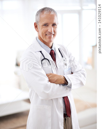 Portrait, medicine and doctor man with arms crossed in hospital for support, services and wellness. Healthcare, lens flare and happy mature medical professional for confident, smile and treatment 141029514