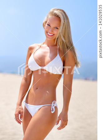 Summer, beach and portrait of woman in bikini on vacation, adventure or holiday for travel. Smile, excited and young female person in swimwear on tropical weekend trip by ocean or sea in Australia. 141029535