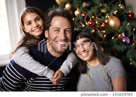 Christmas, family and portrait of parents with girl in home for celebration, festival and season event. Happy mom, dad and child bonding, relax and embrace for holiday, vacation and festive party Christmas, family and portrait of parents with girl in home for celebration, festival and season event. Happy mom, dad and child bonding, relax and embrace for holiday, vacation and festive party 141029765