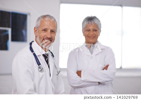 Teamwork, crossed arms and portrait of doctors in hospital for collaboration, insurance and support. Healthcare, clinic and confident man and woman smile for medical care, service and consulting Teamwork, crossed arms and portrait of doctors in hospital for collaboration, insurance and support. Healthcare, clinic and confident man and woman smile for medical care, service and consulting 141029769