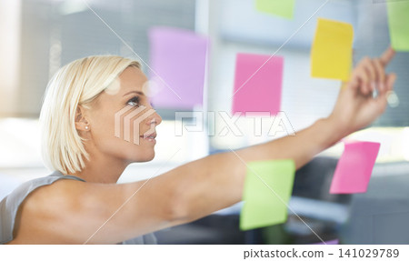 Woman, glass and board with pointing, thinking and notes for planning, proposal and idea development. Person, wall and paper for brainstorming process, decision or choice with smile in modern office Woman, glass and board with pointing, thinking and notes for planning, proposal and idea development. Person, wall and paper for brainstorming process, decision or choice with smile in modern office 141029789
