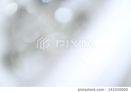 A soft, pale blue bokeh effect against an abstract background with ample negative space. 141030000