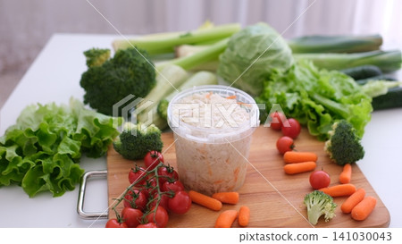 Fork with healthy sauerkraut beside fresh vegetables on rustic wooden table Fork with healthy sauerkraut beside fresh vegetables on rustic wooden table 141030043